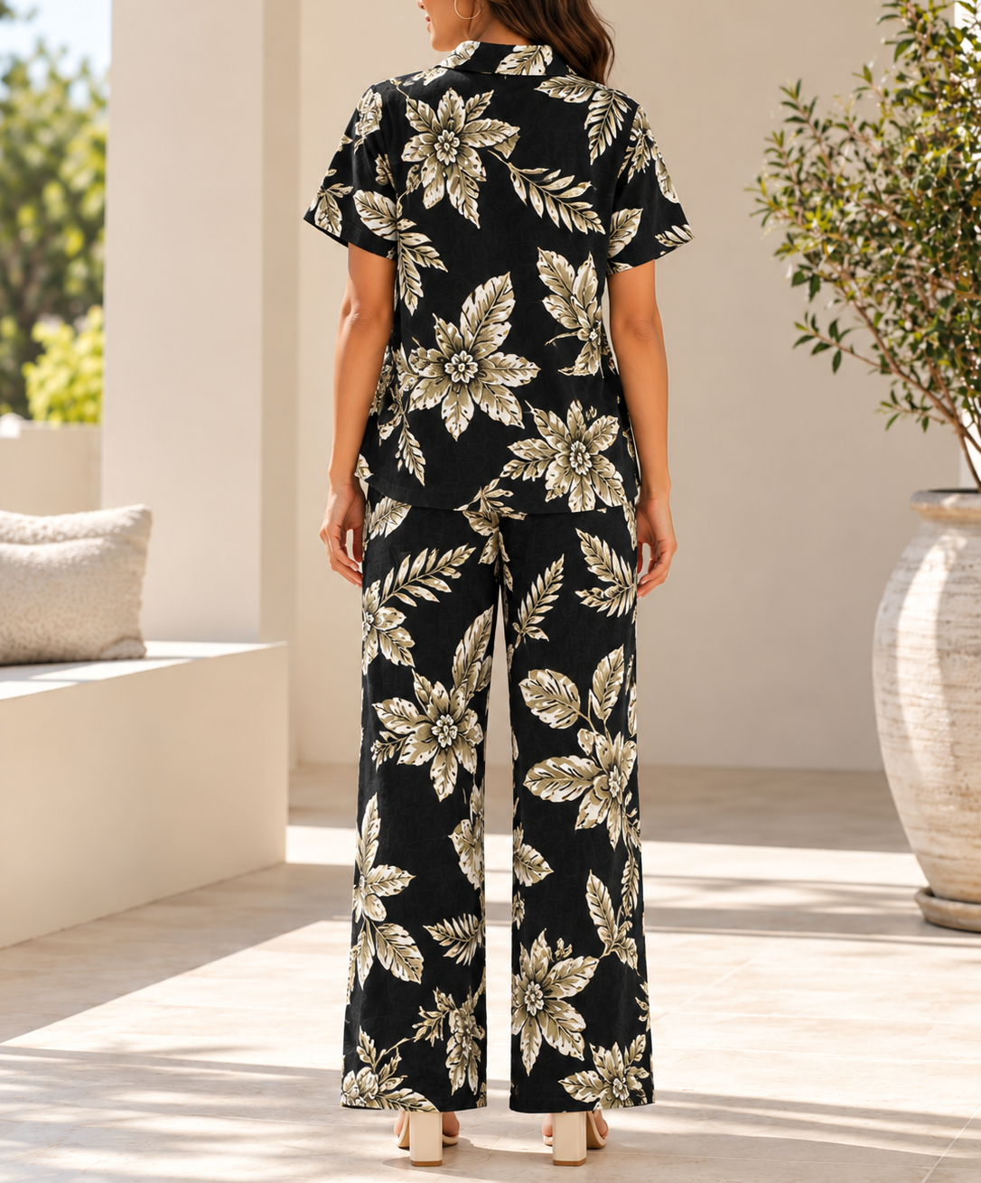 Back view of ladies black and cream floral two piece set