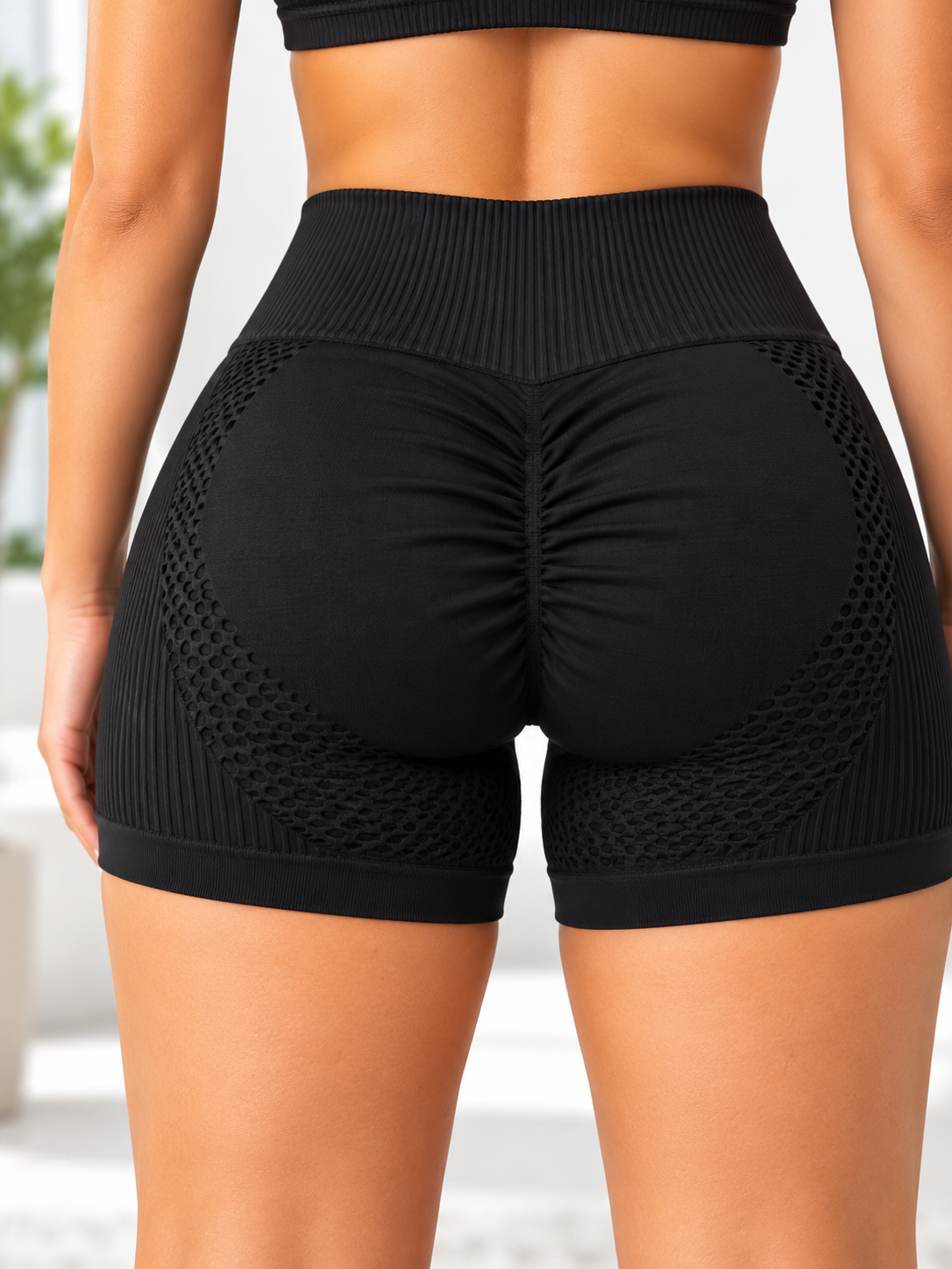 Ladies black textured scrunch gym shorts side view