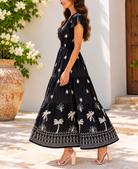 Back view of black and cream palm print maxi dress