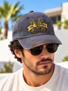 Men's charcoal washed baseball cap with yellow M embroidery and decorative peak