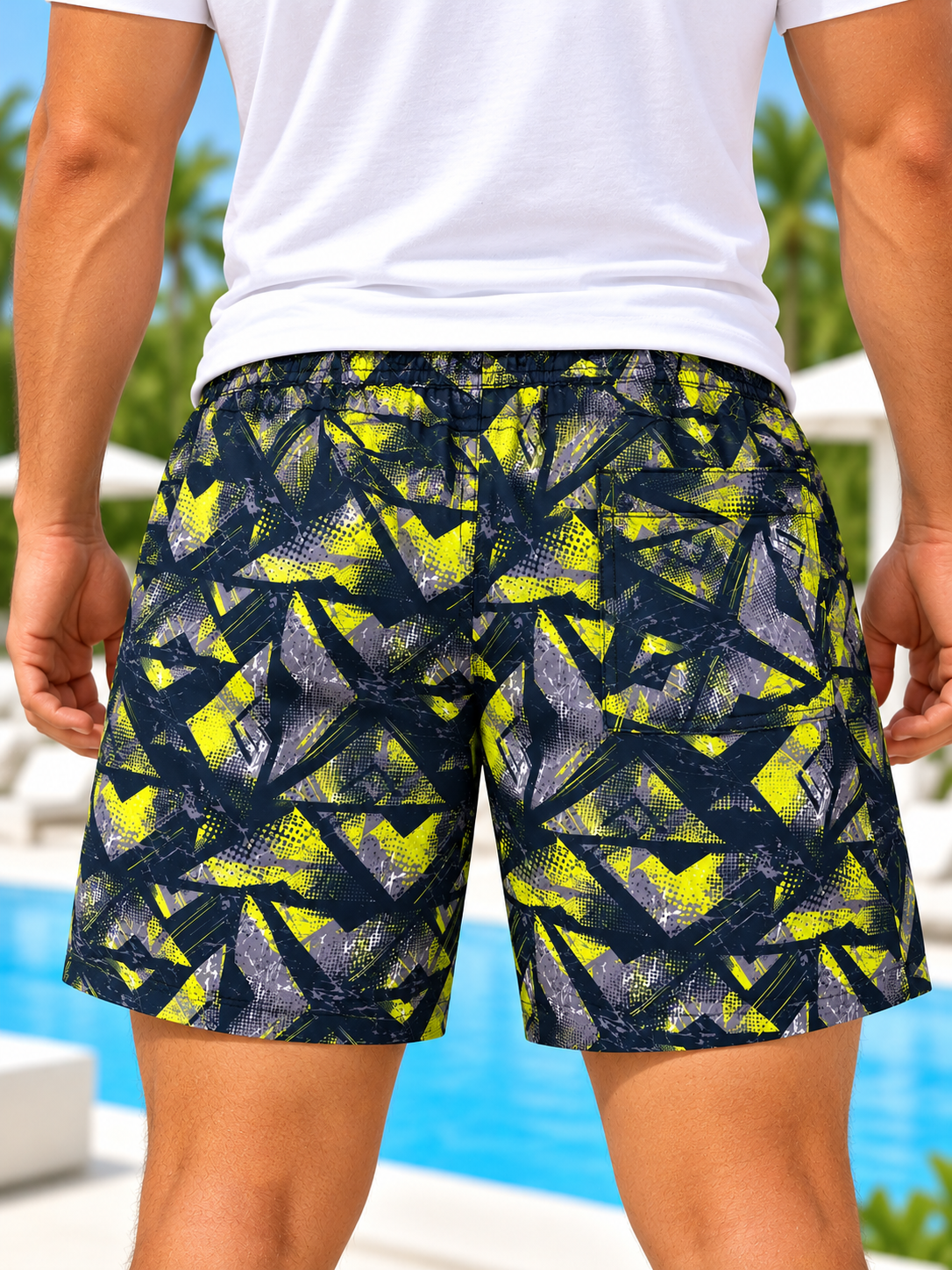 side view of men's navy and neon yellow abstract print shorts
