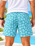 Front view of men's turquoise tropical leaf print shorts