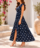Front view navy polka dot tiered maxi dress