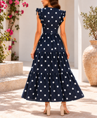 Side view navy polka dot tiered maxi dress