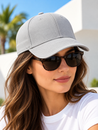 Light grey plain baseball cap worn by female model with sunglasses
